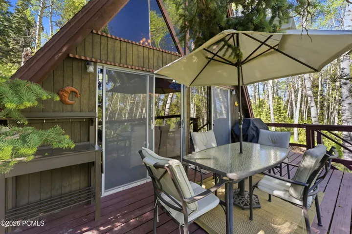 Large deck nestled among mature trees creates a true mountain retreat experience. Whether enjoying coffee, outdoor meals, or quiet afternoons, this private outdoor space offers a seamless connection to the surrounding forest setting.