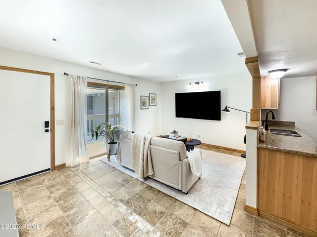 Entryway & living room with large TV