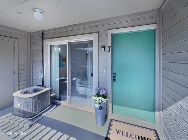 Front door with A/C condenser and small owners closet