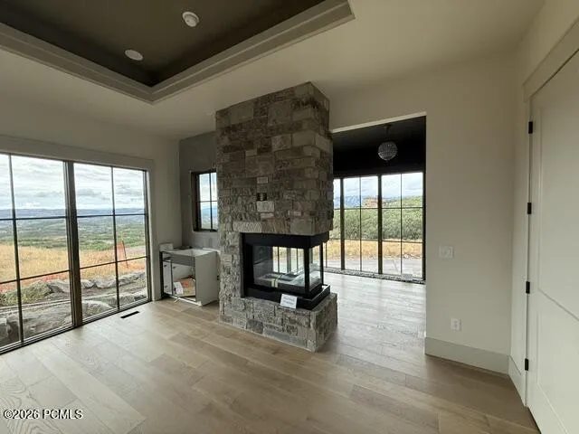 Owner's suite featuring a peninsula fireplace