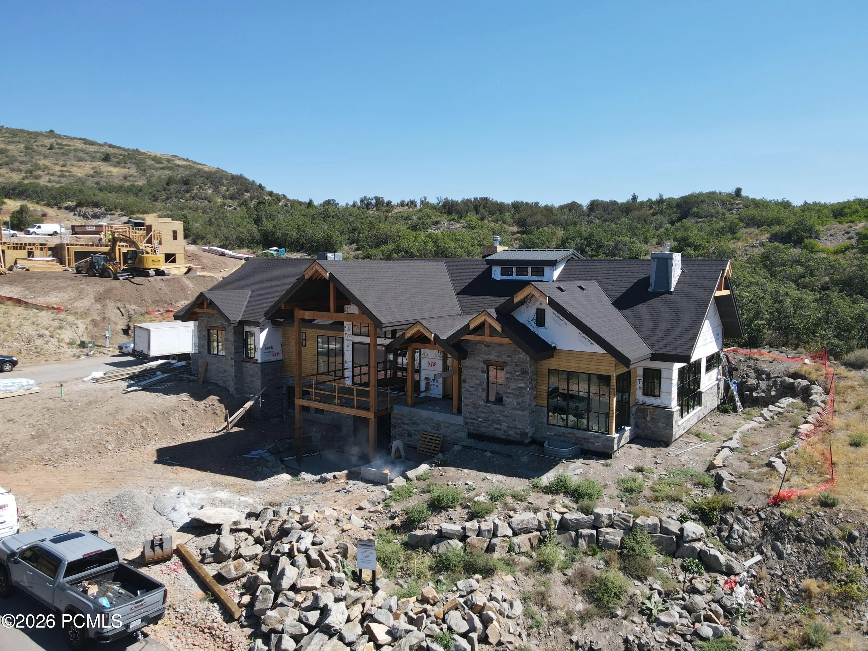 Front of home featuring a boulder retaining wall