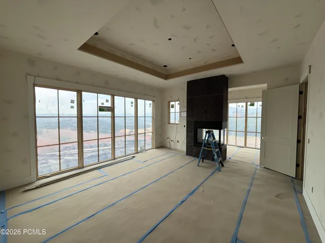 Owner's suite featuring a peninsula fireplace