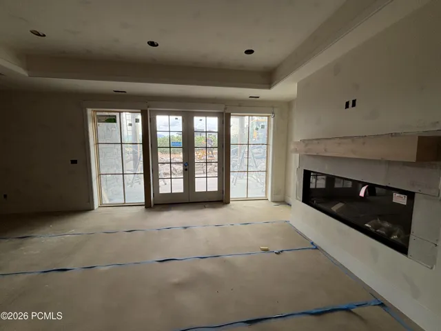 Basement living room featuring a fireplace and french doors
