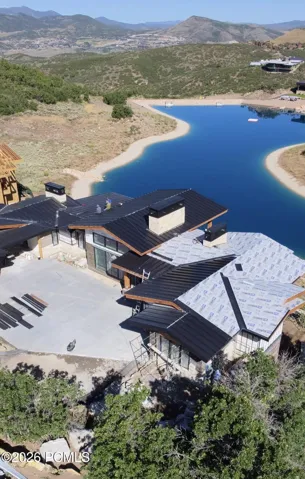 Drone pic of roof/exterior with pond behind the home