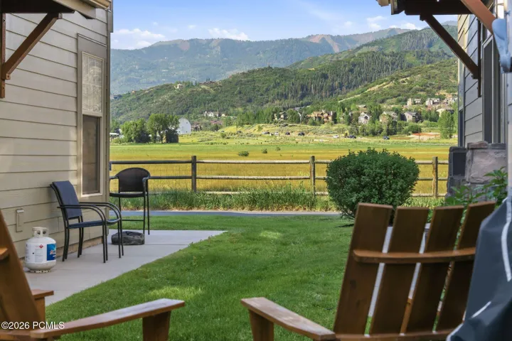 Private patio with mountain views and green space — outdoor relaxation area off this Park City townhome with trail access out back.Test