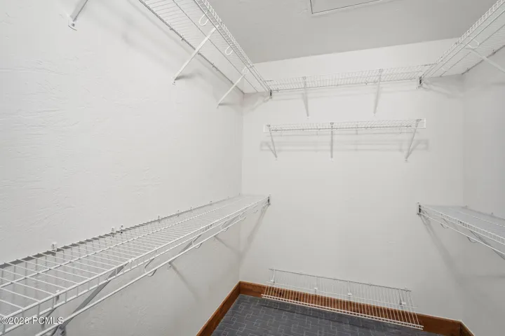Primary suite walk-in closet with custom wire shelving system — generous storage in the primary bedroom of this Park City townhome at 1603 W Redstone Ave A1.