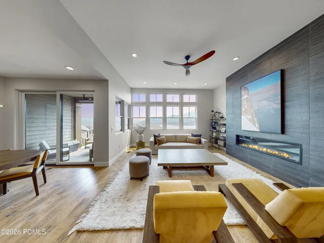Living Room with fireplace to the right and dining area to the left.