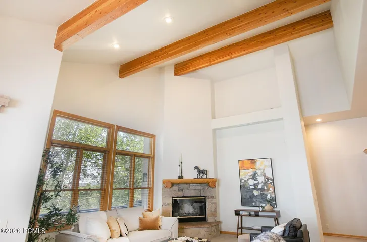 Distinctive architectural character sets this home apart, with soaring vaulted ceilings and exposed wood beams that create a warm, spacious, and memorable first impression.