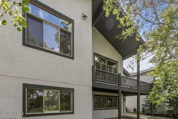 Lower-level sliding glass doors and windows fill the space with natural light, creating bright, welcoming connection to the outdoors.