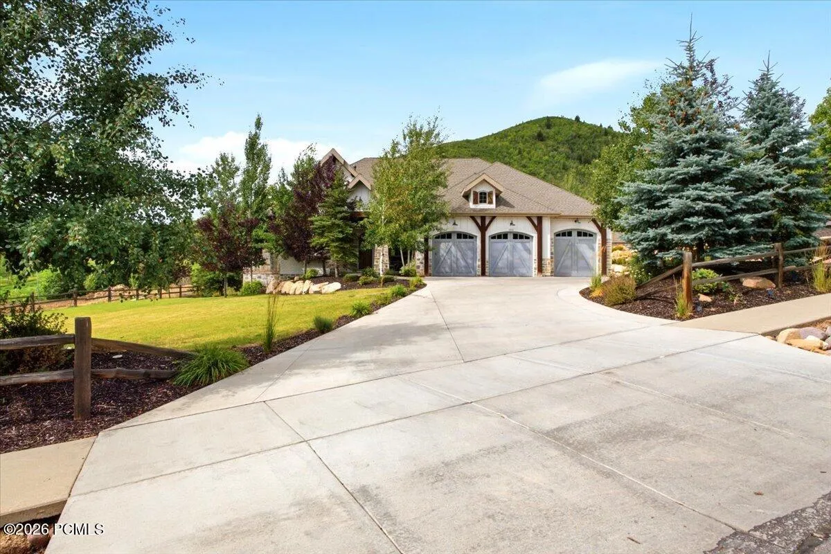 Street view of driveway leading to a three-car garage