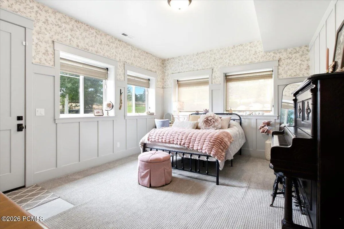 Bedroom featuring four windows and separate entry