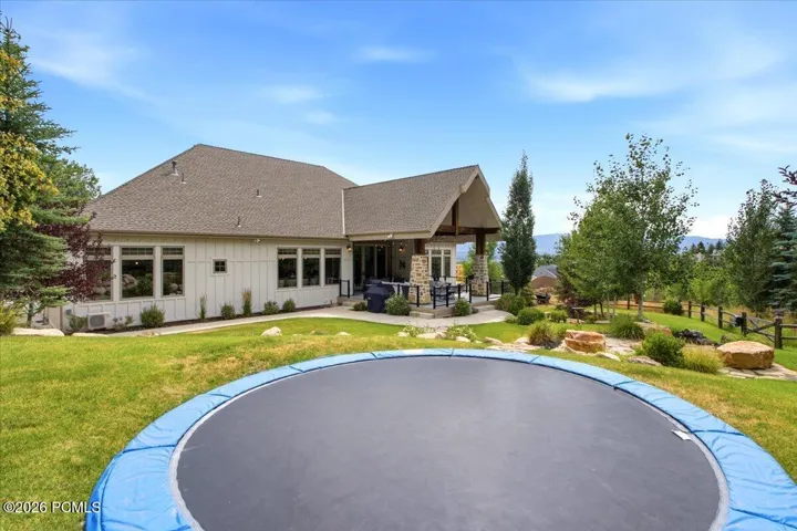 Expansive backyard featuring in ground trampoline