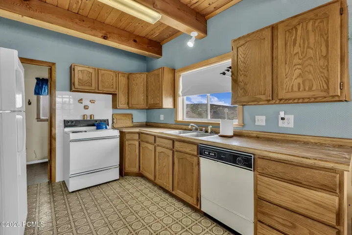 Kitchen featuring wood cabinetry.