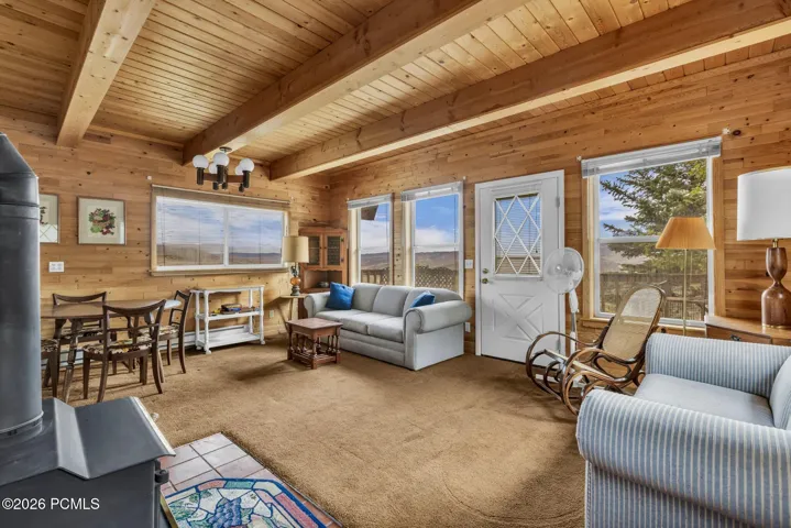 Exposed wood beams and open floor plan.