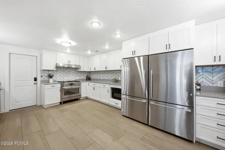 Spacious and recently update kitchen with large gas range, two refrigerators, and tons of countertop space