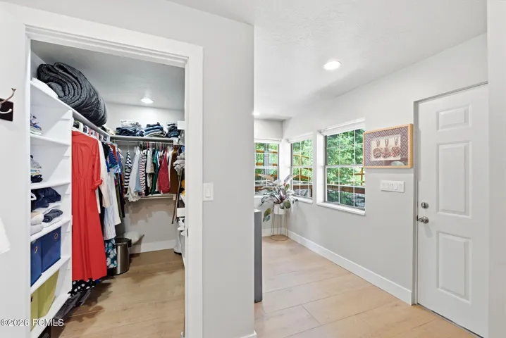 Walk-in closet with custom shelving. Primary suite has another closet not pictured