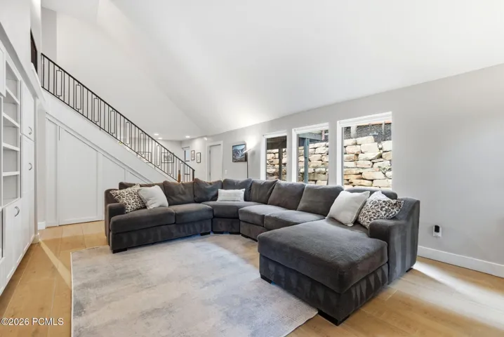 Second level Family Room looking toward the staircase to the third floor, with access to the back deck and hot tub