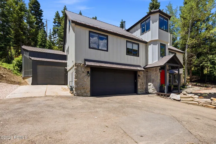 three car garage with tons of storage shelves and electric vehicle charging