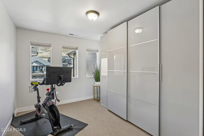 MORE Contemporary Illuminated Closet storage off the Primary Suite with Versatile Office/Den space - currently being used as a Work out area.