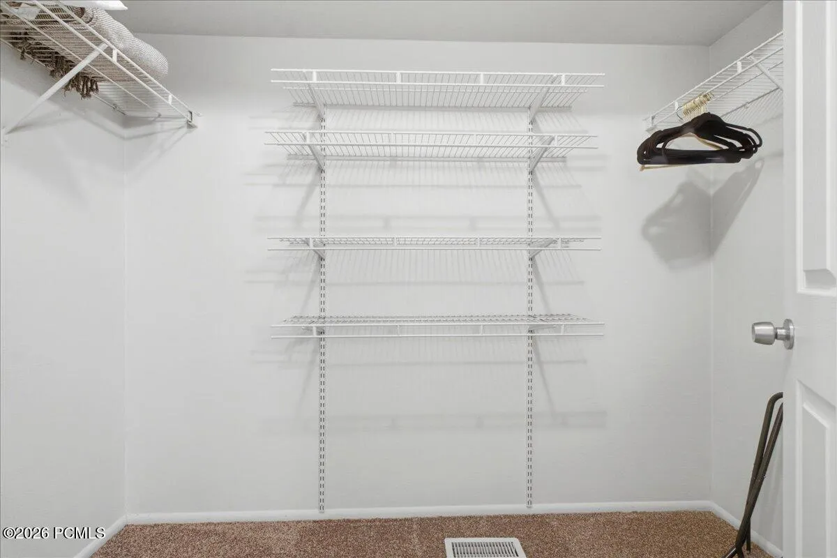 Spacious primary walk-in closet.