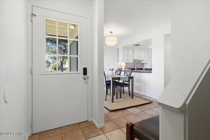 Keyless entry front door opens directly into the bright main-level dining and kitchen