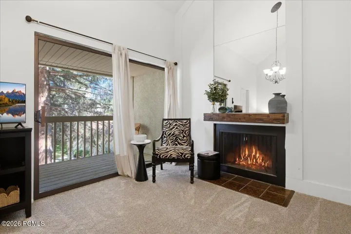 Bedroom sanctuary features extra sitting room and a relaxing fireplace.