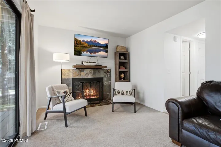 This warm and inviting living space features a cozy gas fireplace.