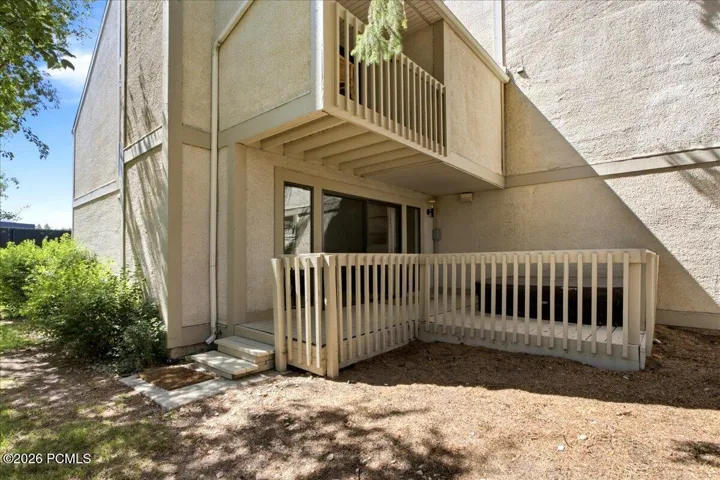 Expansive back deck features a built-in hot tub.