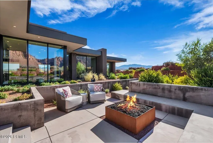 Outdoor lounge area with built in fire pit off of the main kitchen area