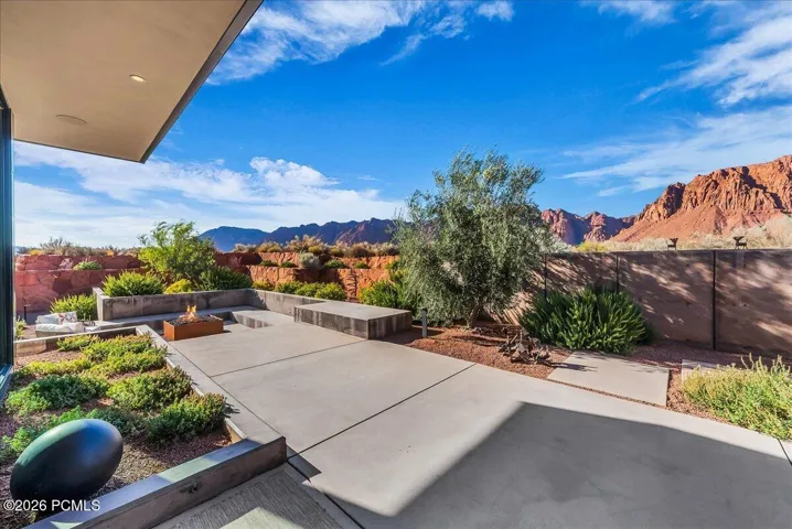 Outdoor lounge area with built in fire pit off of the main kitchen area
