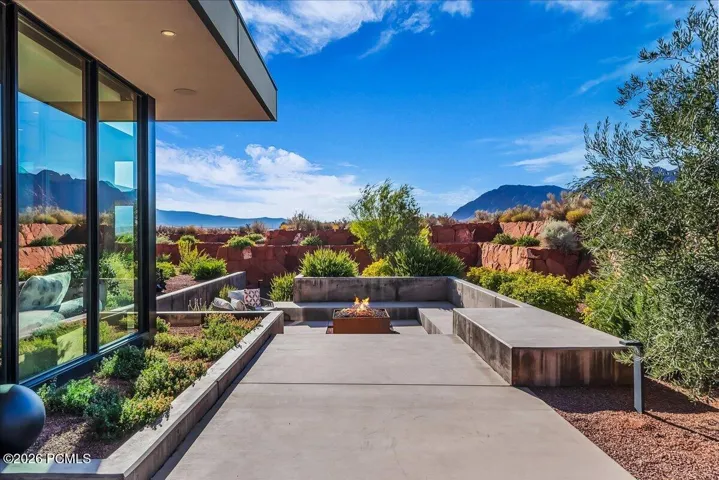 Outdoor lounge area with built in fire pit off of the main kitchen area