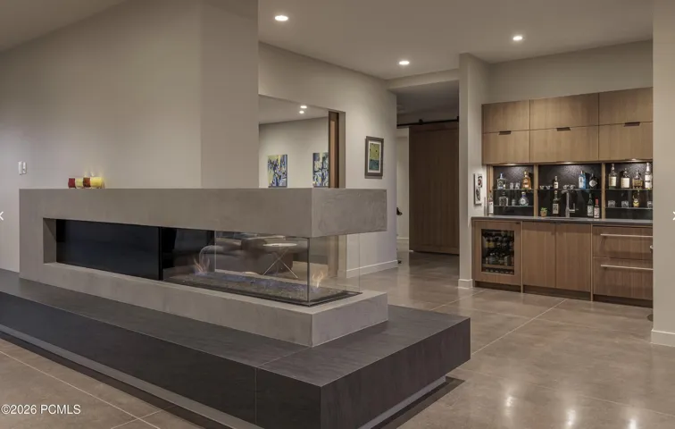 Great room three sided gas fireplace and wet bar