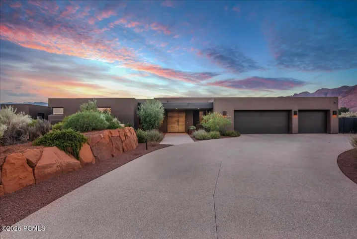 Modern desert-style residence with a flat roofline and dark stucco exterior