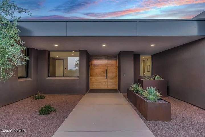 Modern exterior featuring a custom entry door