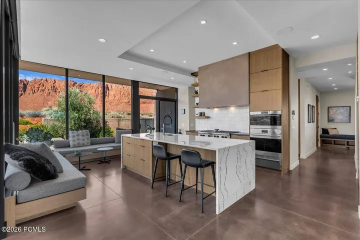 Kitchen to the dining room area with cascading Calcutta Quartzite countertops