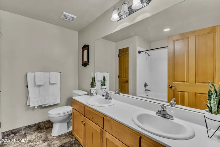 Master bathroom, double vanity, tub, and linen closet.