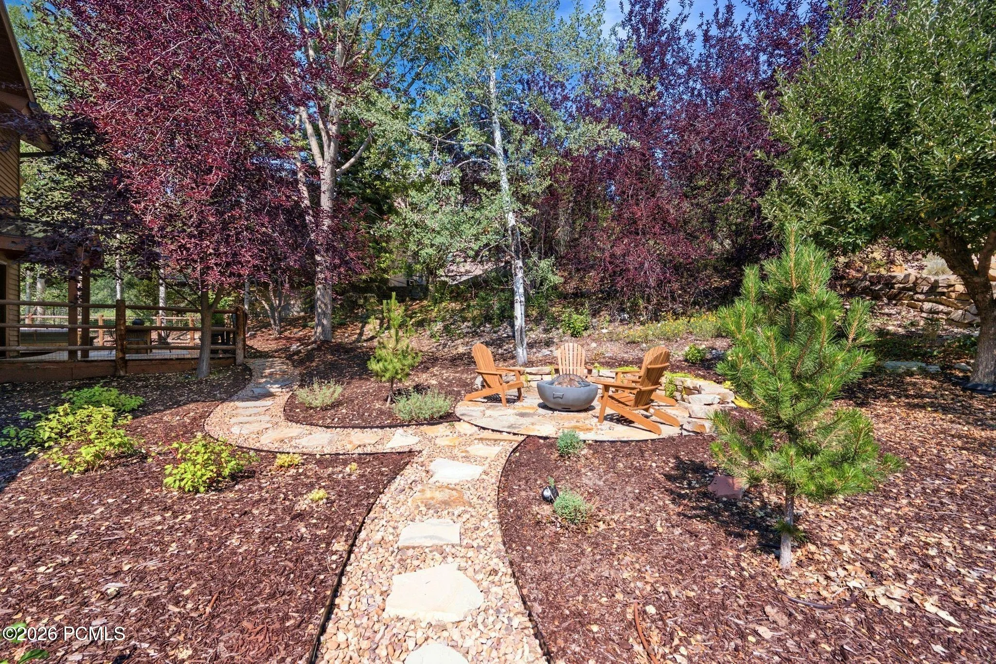 Stone paver pathway leading to a stone fire pit area in the back/side yard. Imagine getting out the gravity chairs and taking in the stars or sunsets.