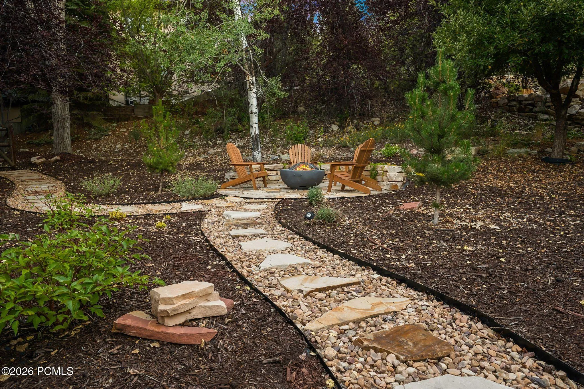 Stone paver pathway leading to a stone fire pit area in the back/side yard. Imagine getting out the gravity chairs and taking in the stars or sunsets.
