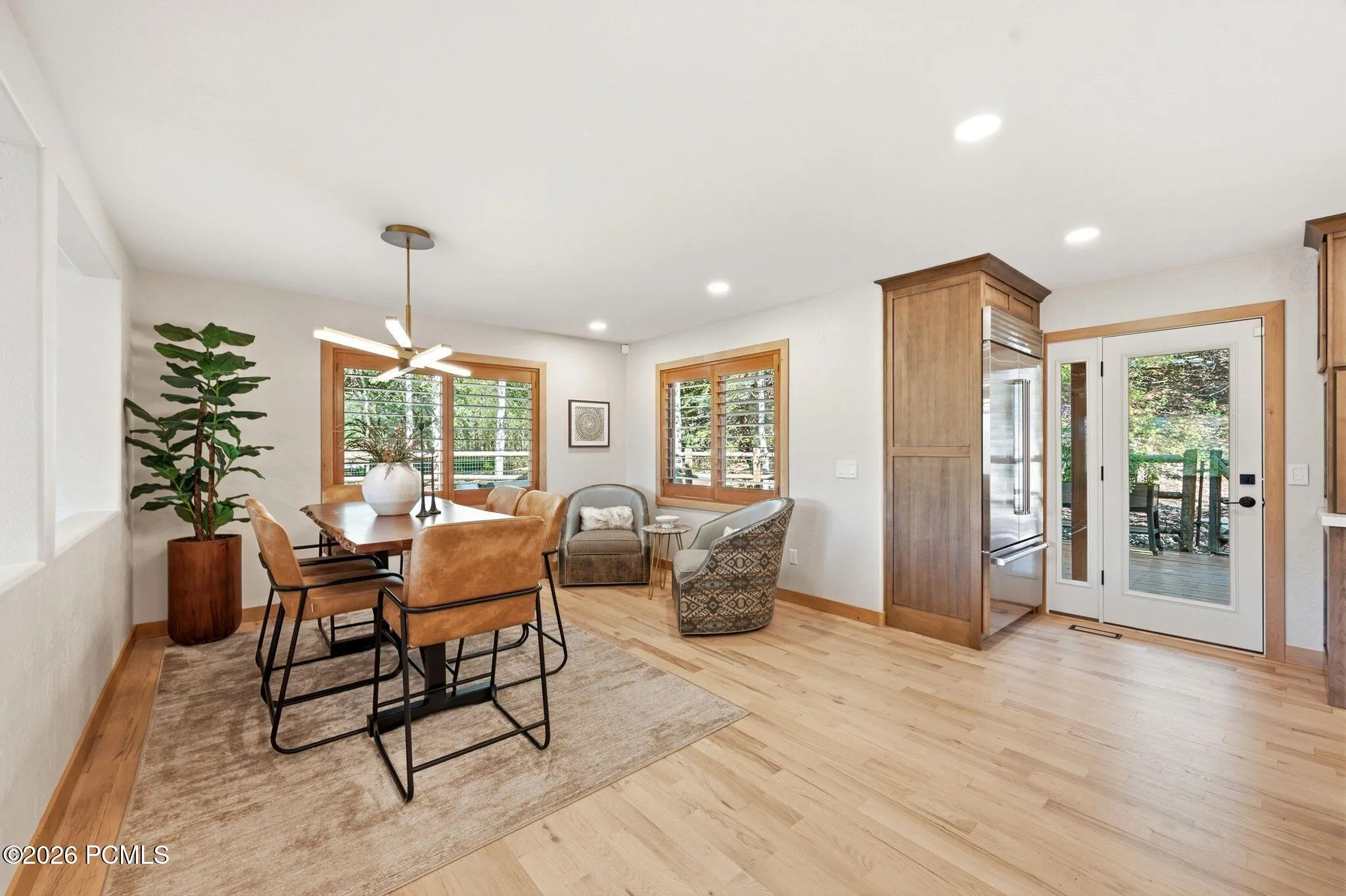 Refinished hardwood flooring extends throughout this open living space. Easy access to the back deck and outdoor living space. Views from your dining table.