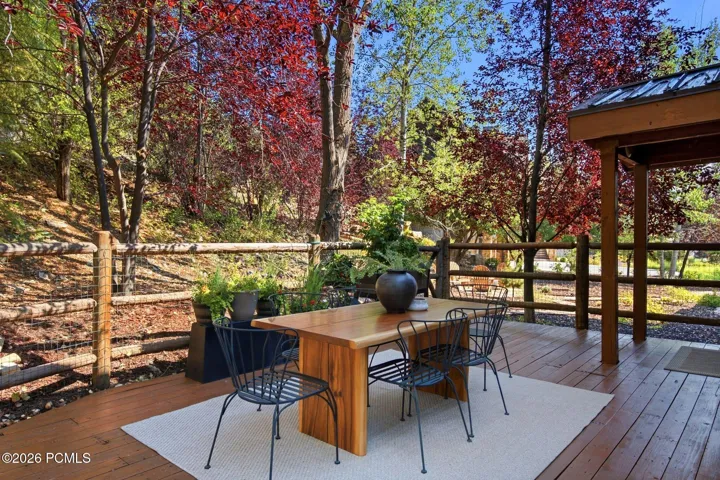 Secluded and private back deck right off the kitchen and dining room with multiple seating areas for entertaining, relaxing, working from home, and being immersed in nature. The home often sees moose, deer, rabbits, squirrels, birds and less commonly elk, bobcats, fox and raccoons