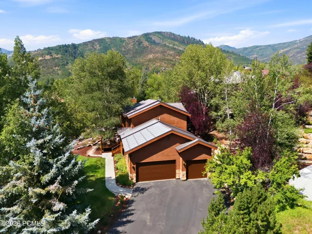 Well maintained wood siding and a 70 year metal roof. 3 car garage with ample storage and additional off-street driveway parking. The lot is covered with mature trees without obstructing your view of the mountains.