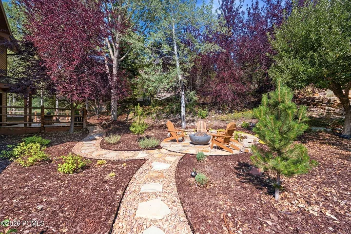 Stone paver pathway leading to a stone fire pit area in the back/side yard. Imagine getting out the gravity chairs and taking in the stars or sunsets.
