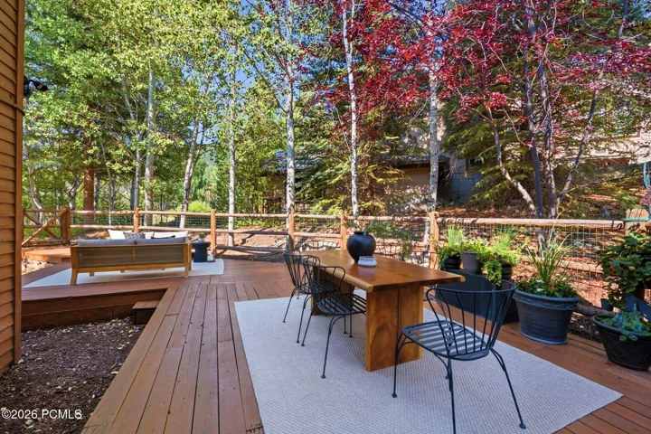 Secluded and private back deck right off the kitchen and dining room with multiple seating areas for entertaining, relaxing, working from home, and being immersed in nature. The home often sees moose, deer, rabbits, squirrels, birds and less commonly elk, bobcats, fox and raccoons