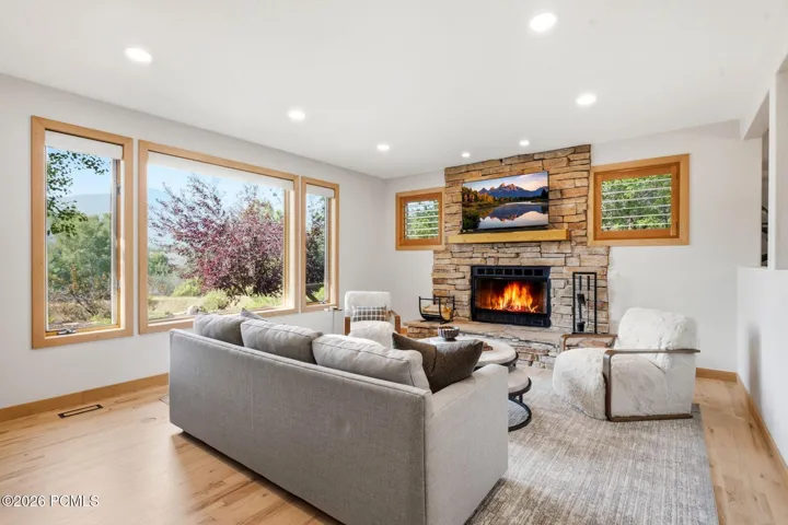 Updated lighting, refinished wood floors, and a cozy fireplace so you can sit in your home and enjoy all the views out your large picture window while being bathed in natural light.