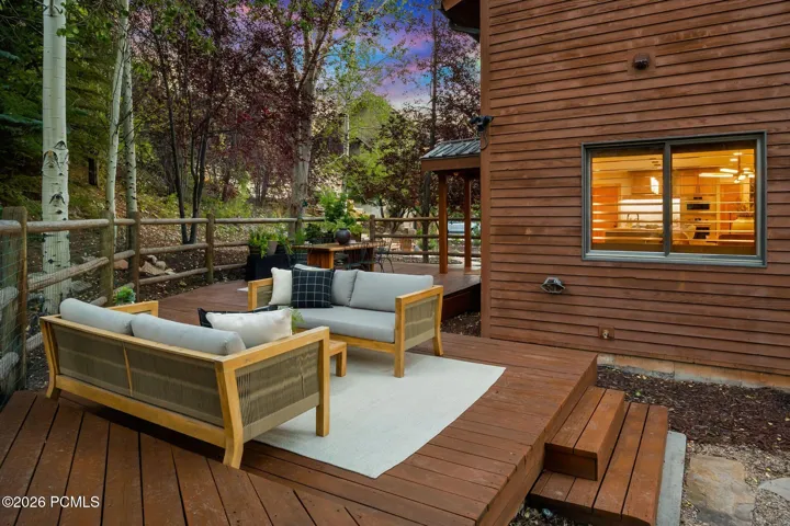 Secluded and private back deck right off the kitchen and dining room with multiple seating areas for entertaining, relaxing, working from home, and being immersed in nature. The home often sees moose, deer, rabbits, squirrels, birds and less commonly elk, bobcats, fox and raccoons