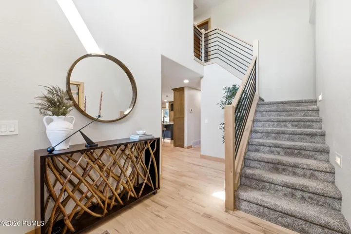 A grand entryway with ample natural light, refinished hardwood flooring, and ample space will be welcoming to any guest.