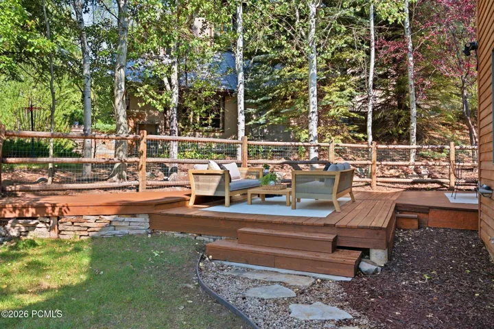 Secluded and private back deck right off the kitchen and dining room with multiple seating areas for entertaining, relaxing, working from home, and being immersed in nature. The home often sees moose, deer, rabbits, squirrels, birds and less commonly elk, bobcats, fox and raccoons
