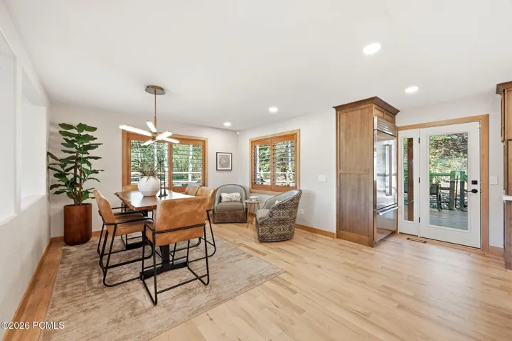 Refinished hardwood flooring extends throughout this open living space. Easy access to the back deck and outdoor living space. Views from your dining table.