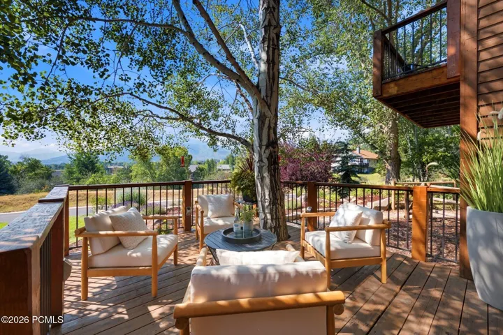 Front deck with a tree integrated into the deck and stunning views of Park City, Canyons, and Deer Valley. Imagine watching the fireworks from your front deck!