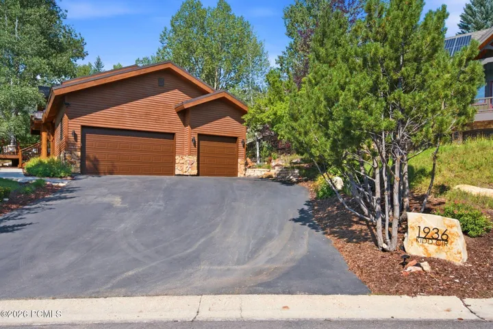 Three-car garage with ample storage areas and additional storage above. Ample off street driveway parking and driveway parking still allows access to the garage doors.